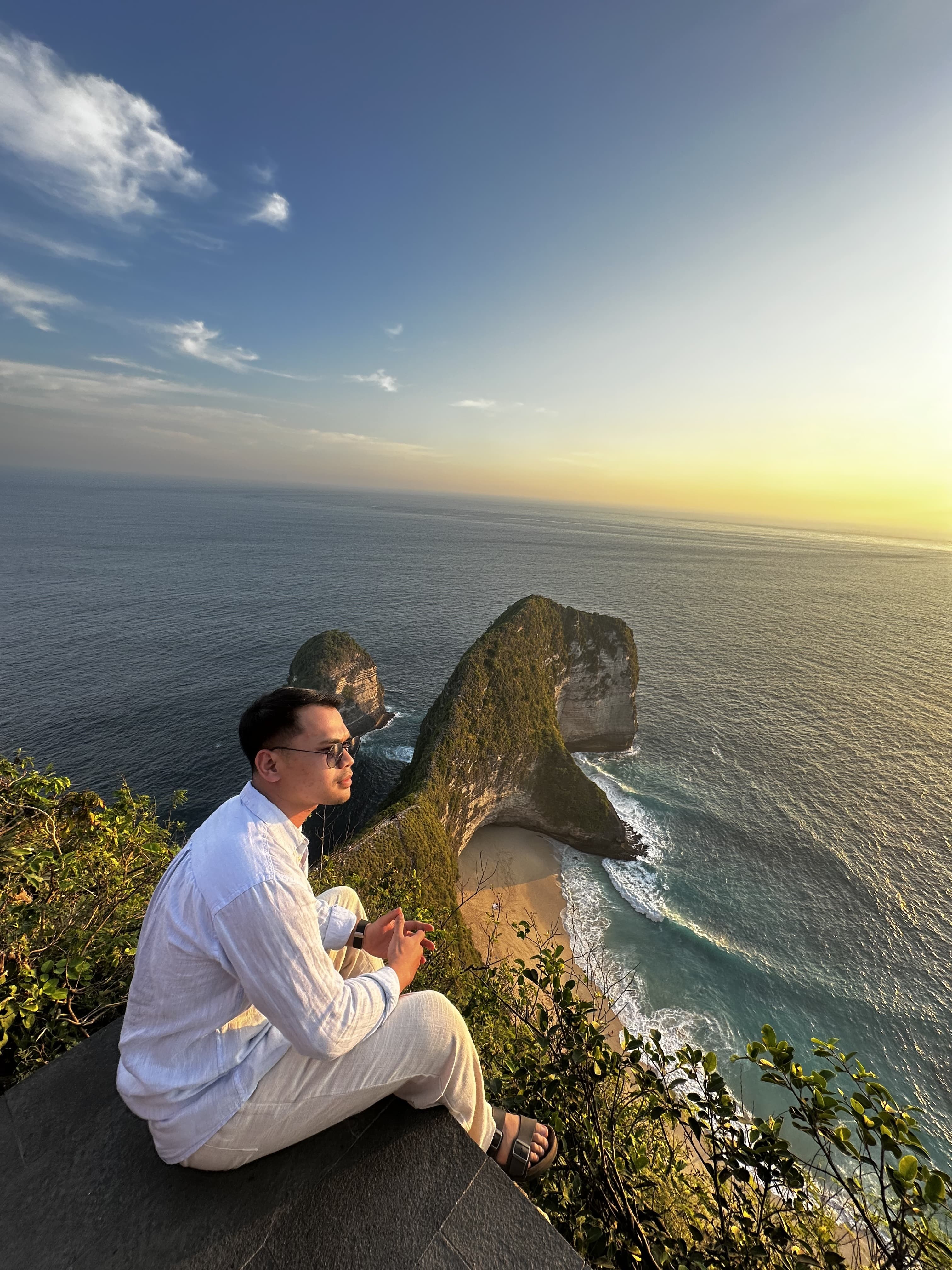 Hida Aldric overlooking the ocean and coastal cliffs at sunset